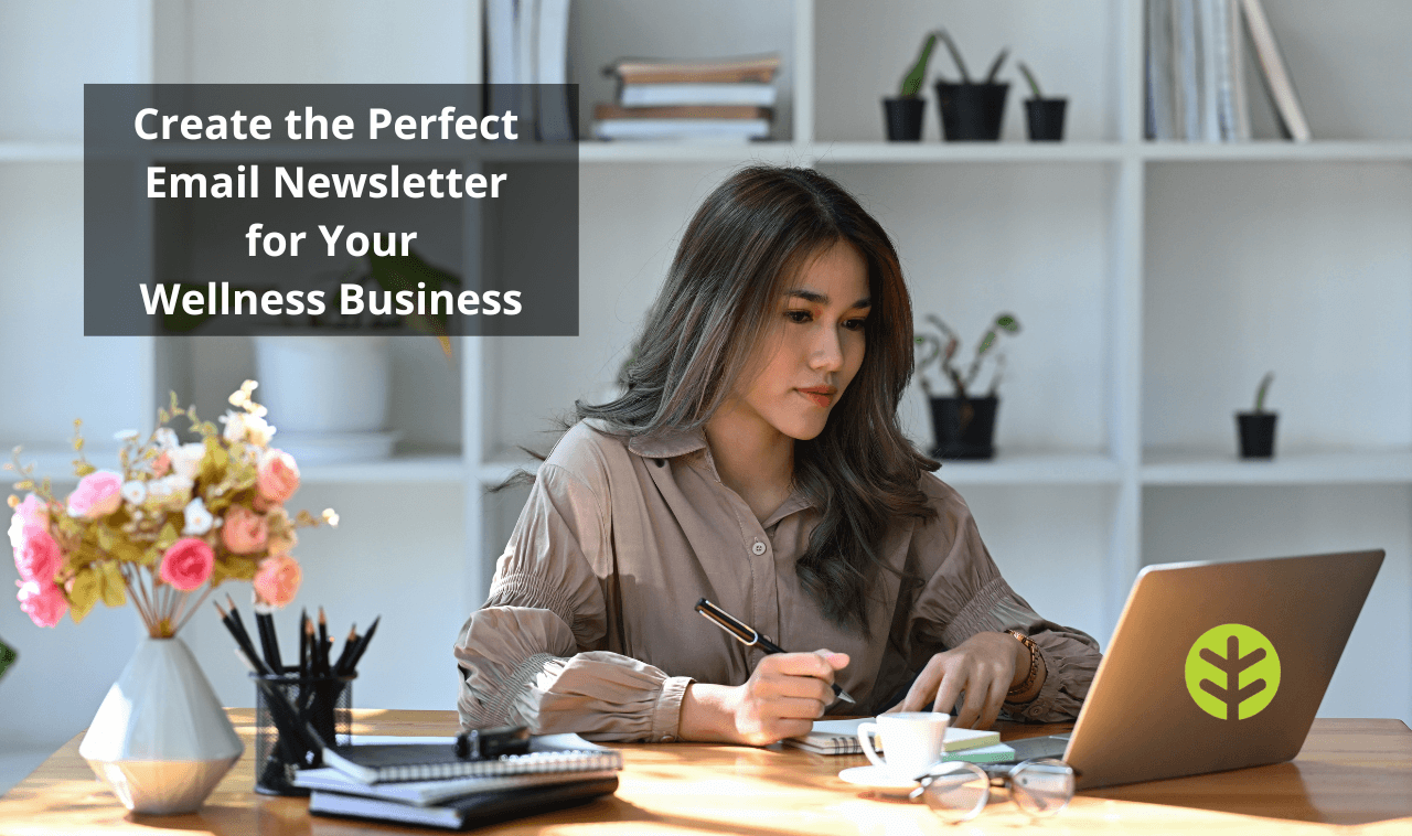 Woman sitting at her desk looking at her computer screen. The image is overlaid with text that says "Create the Perfect Email Newsletter for Your Wellness Business.