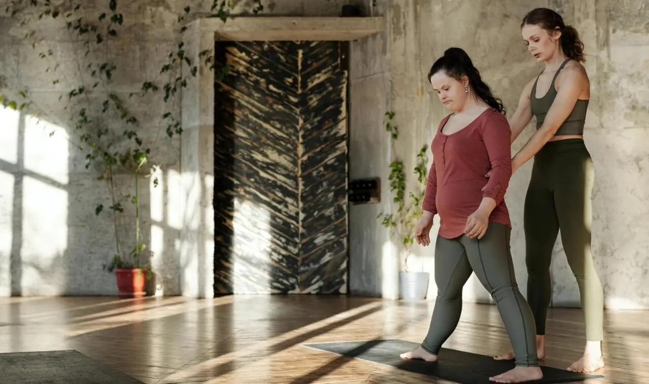 helping client with a pose | OfferingTree Yoga teacher helping a client with a post