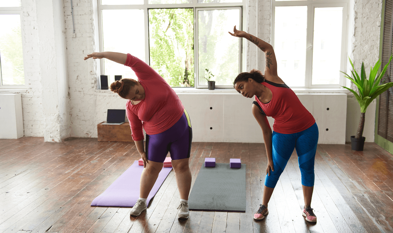 women stretching in a gym studio
